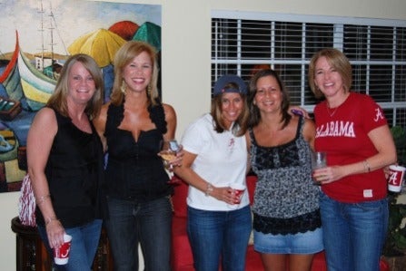 group of people standing in front of dark wall