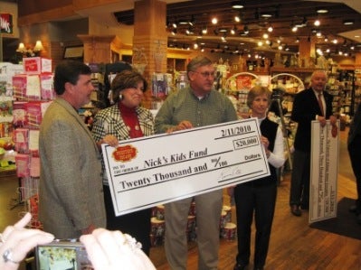 Group of people holding poster in front of display