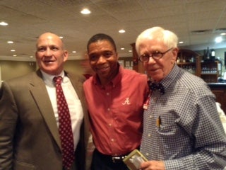 Group of people standing in a room with dim light.
