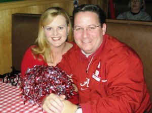 Two people in red shirts sitting at a table.