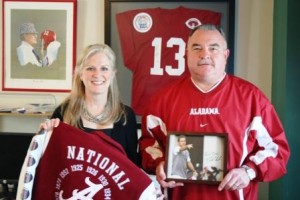 Two people standing in front of red jersey.