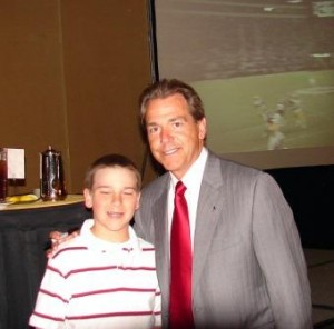 Coach Nick Saban standing with a student.