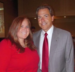 Coach Nick Saban standing with a student.