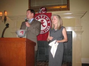 Two people standing behind podium.