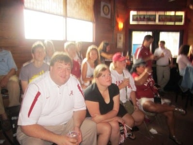 Group of people sitting in front of a window listing to a speaker