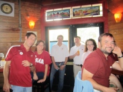 Group of people standing in front of window.