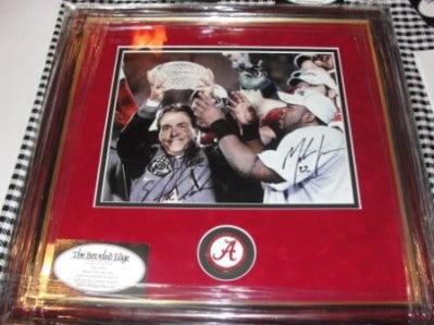 Framed picture with red mat of Coach Nick Saban and football team.