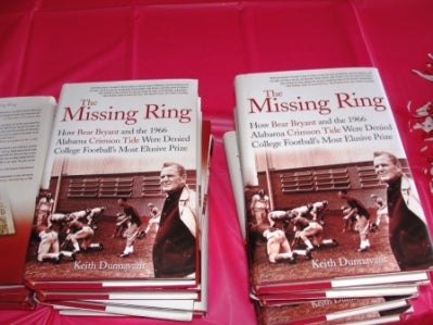 Picture of two books with red background.