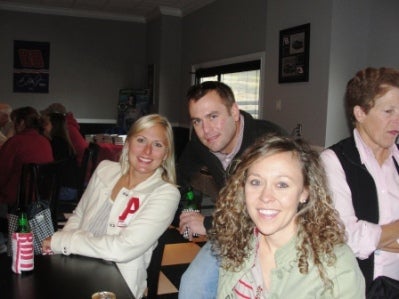 Group of people sitting in room with dim light.