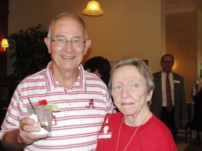 Man in red and white stripped shirt and lady in red shirt.