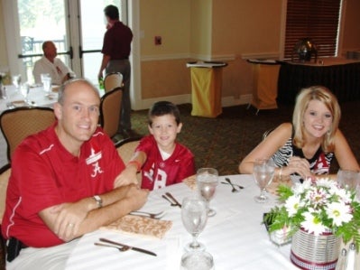 Group of people sitting at table with window in background.