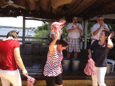Group of people standing in front of window.