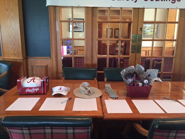 Table with white papers on it in front of glass door.