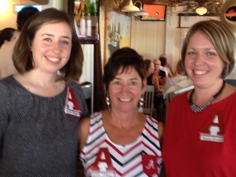 Group of people standing in room.
