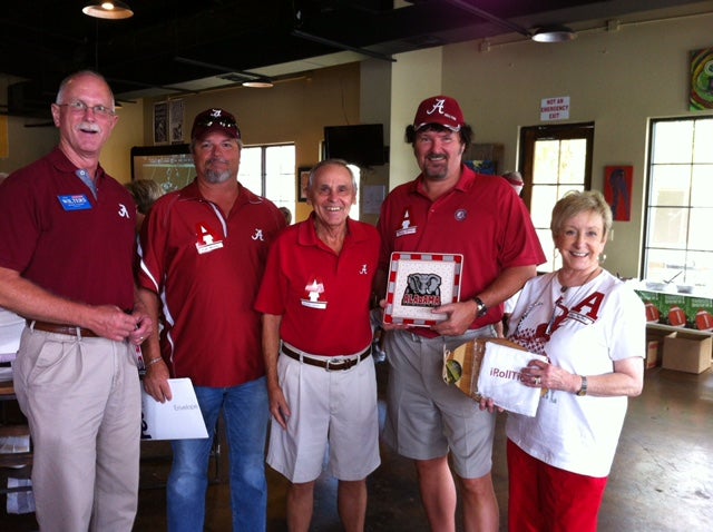 Group of people standing in room with dim light.