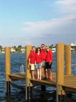 Group of people standing on pier outside.