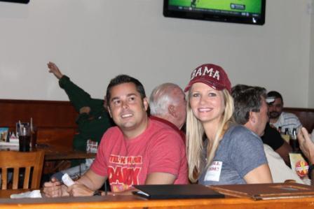 Man in Red shirt and lady in Gray shirt with red BAMA cap.