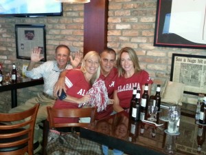 a man and two ladies in a brick restaurant