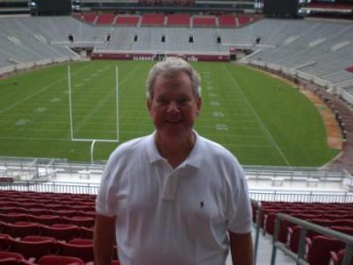 Man standing in football stadium.