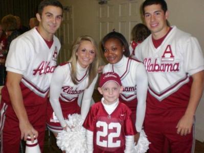 Group of people dressed in red and white standing in room.