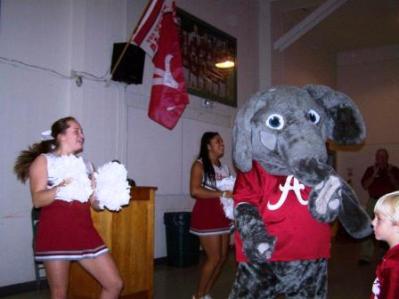 Two Alabama cheerleaders with Big AL.