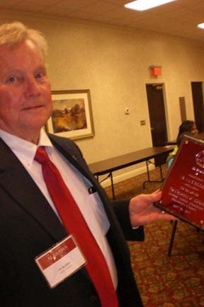 One person standing in room with beige wall.