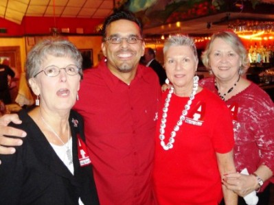 Four people standing in room with red ceiling.