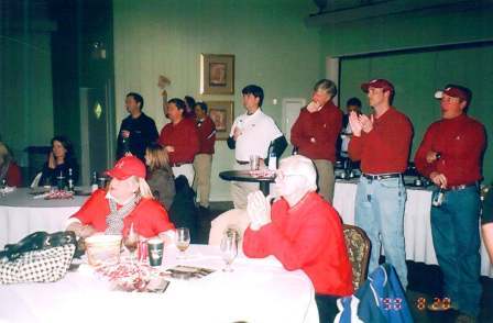 Group of people in room with green wall.