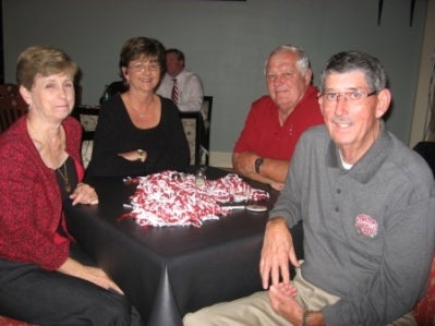 Group of people sitting at black table.