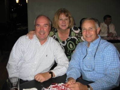 Group of people sitting in room with dim light.