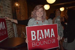 lady holding a red Bama Bound sign