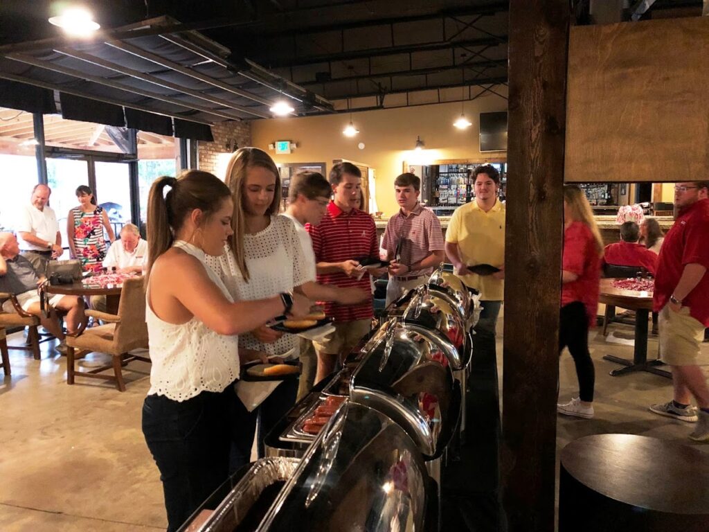Group of people in buffet line.