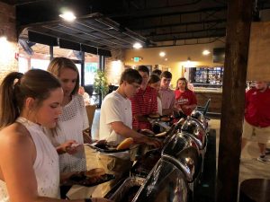 Group of people in buffet line.