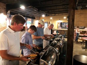 Group of people in a buffet line.