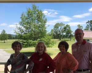 Four people standing outside.