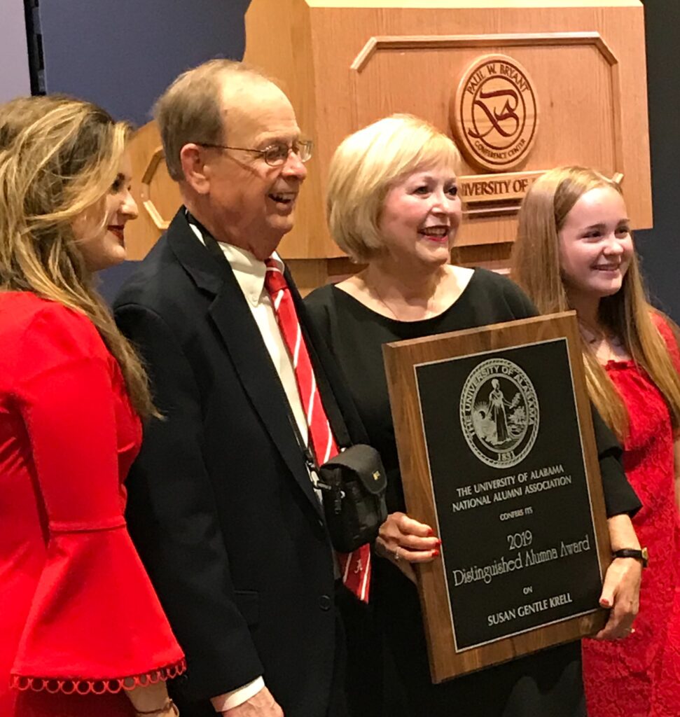 Susan and Jim Krell with two ladies dressed in red