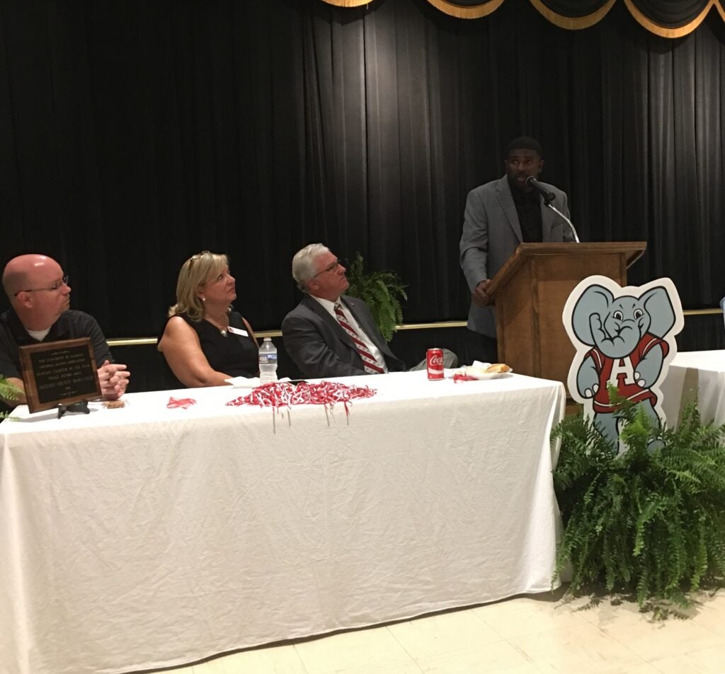 people sitting behind table with white table cloth
