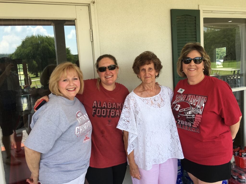 group of people standing in front of white wall