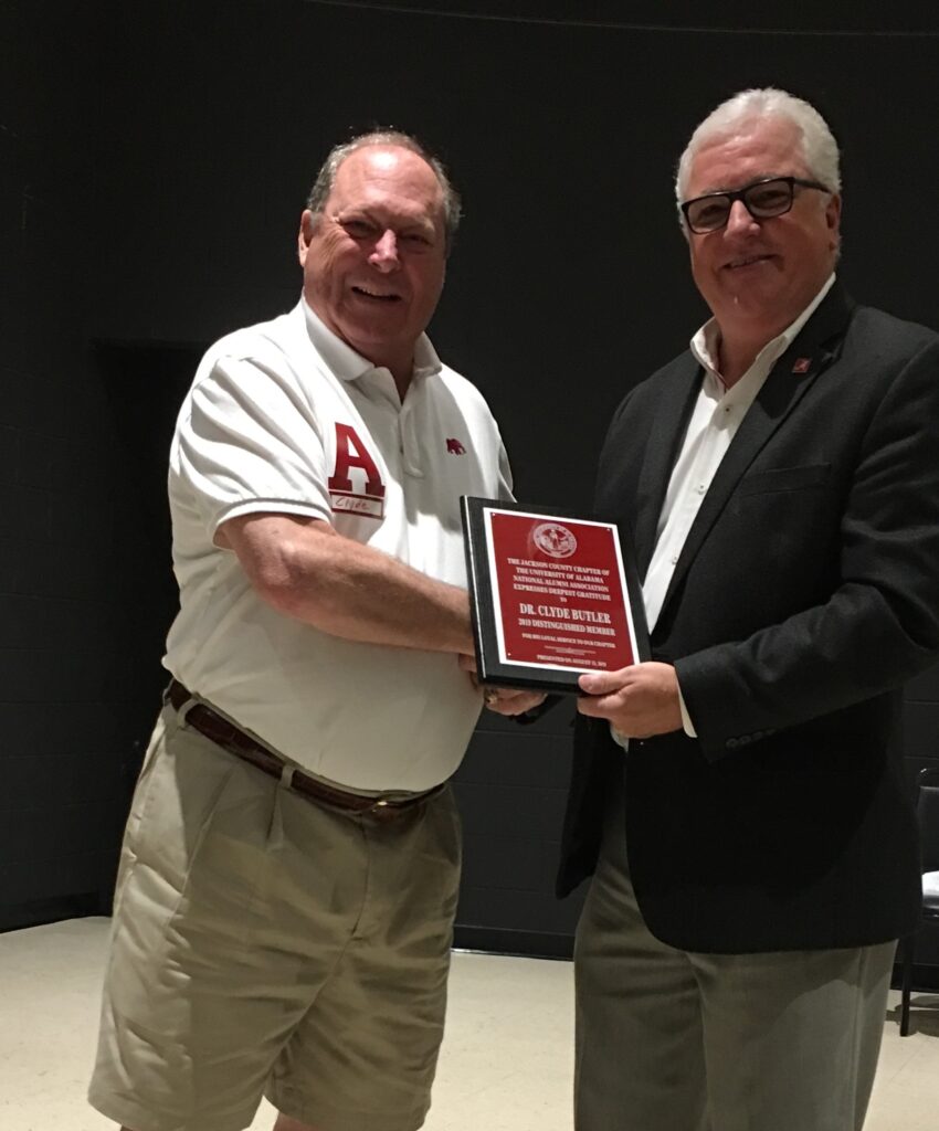 Rick Roden presenting award to man in white shirt