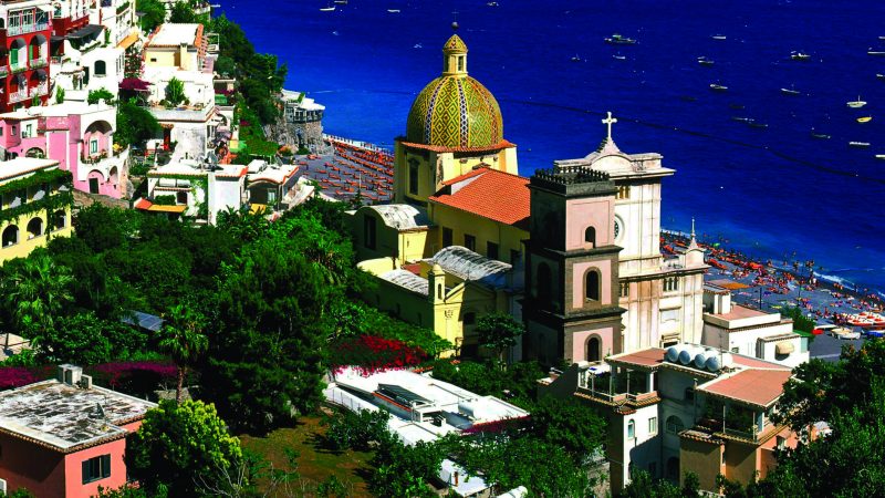 An areal shot of the village of Positano during a sunny day.