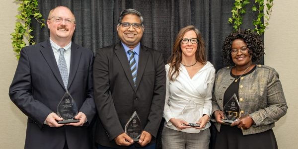 UA faculty members holding OCTA awards